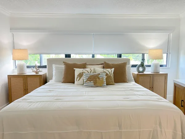 a large white bed in a white room