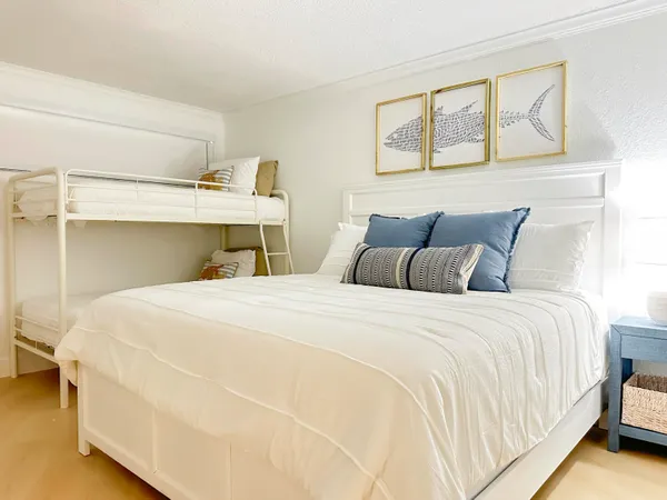 a bedroom with a bed and a night stand