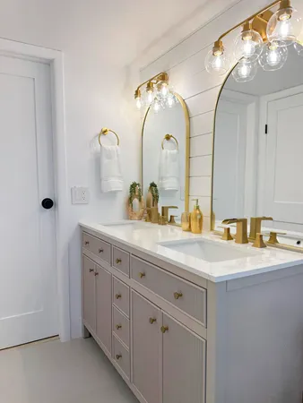 a bathroom with a granite countertop sink a large mirror and a shower