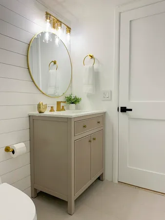 a bathroom with a sink mirror vanity and toilet