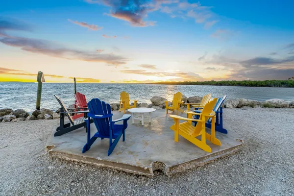 a view of a patio with table and chairs and potted plants