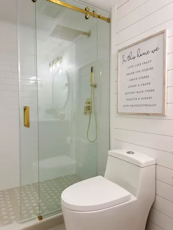 a bathroom with a toilet and a shower