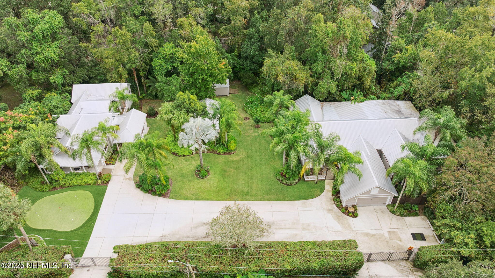 an aerial view of a house with a yard and trees