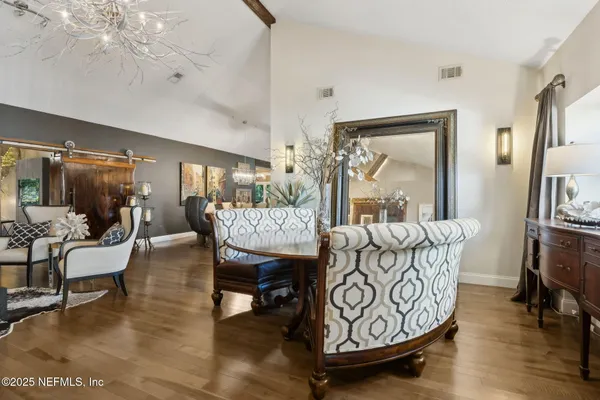 a living room with furniture a floor to ceiling window and a large window