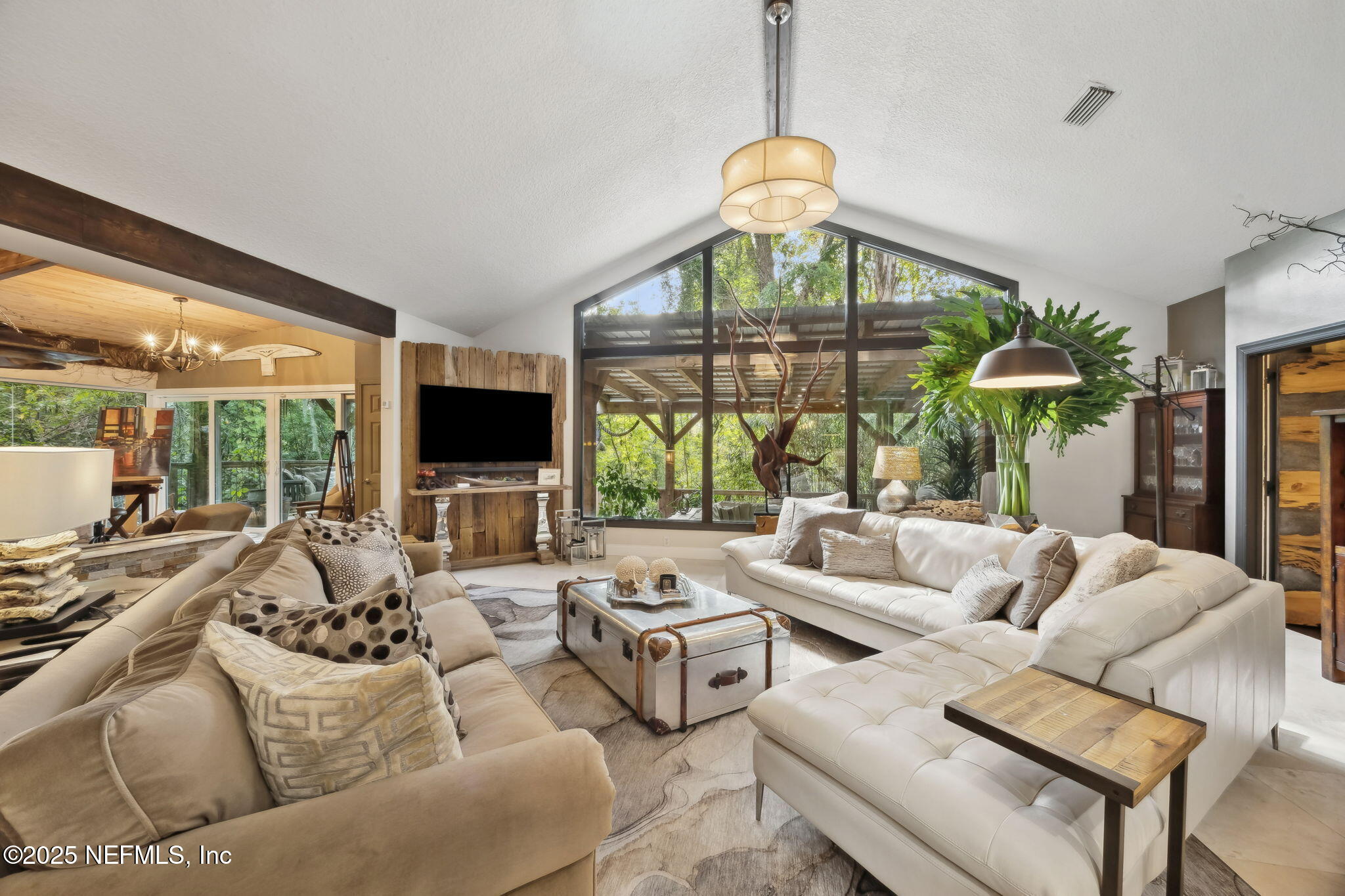 2245 Reed Street Orange Park, FL 32073 - Photo 18 of 107 a living room with furniture a flat screen tv and a large window
