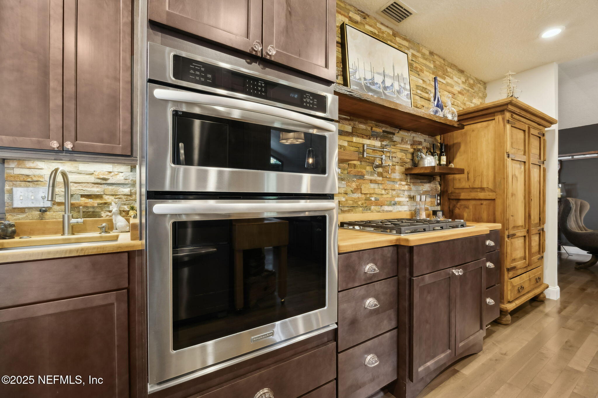 2245 Reed Street Orange Park, FL 32073 - Photo 30 of 107 a kitchen with stainless steel appliances granite countertop cabinets and a stove top oven