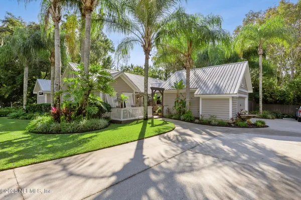 a view of a house with a yard and tree s