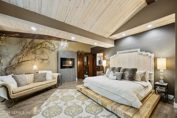 a kitchen with stainless steel appliances a refrigerator a stove a microwave and dining table