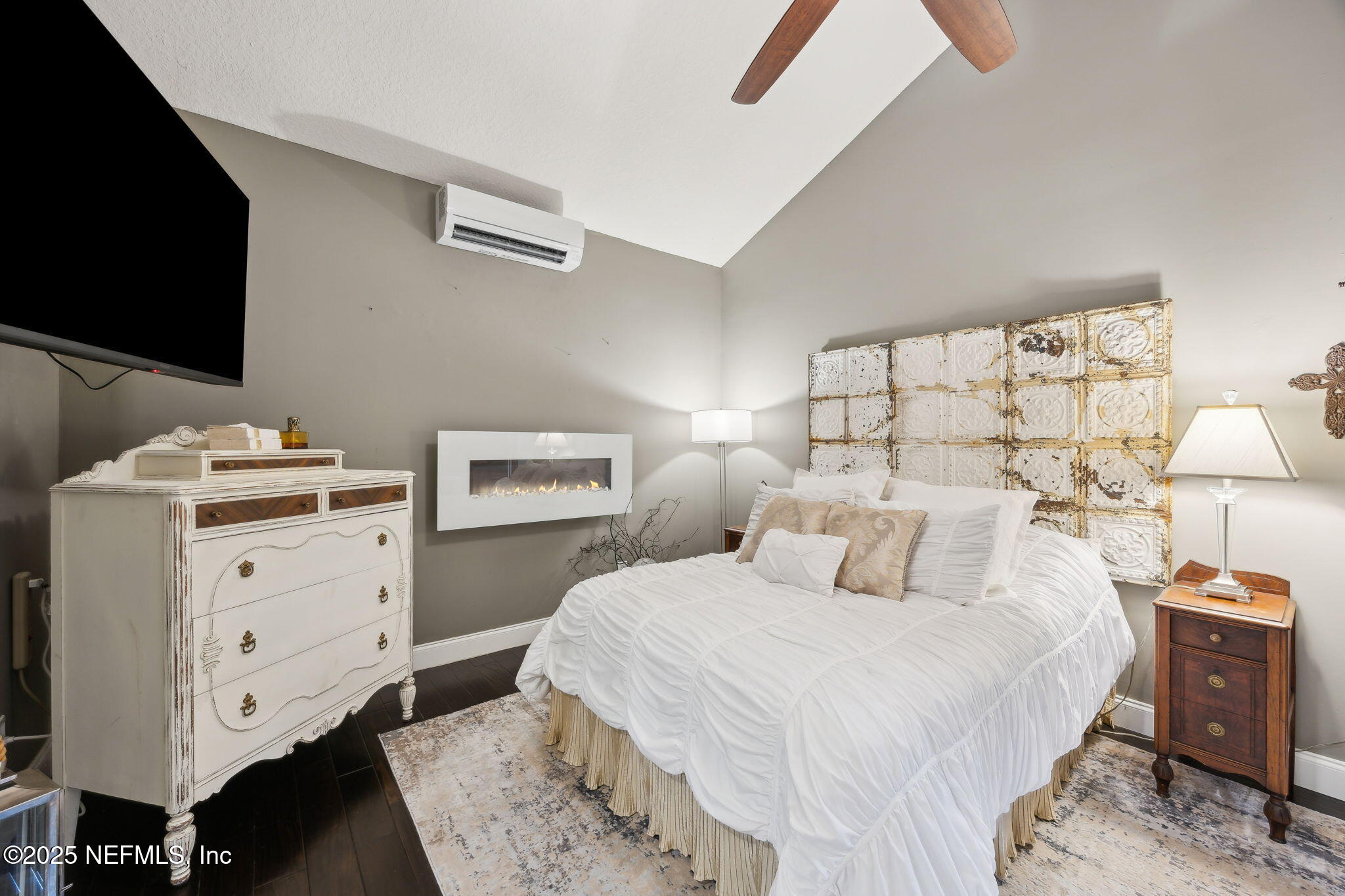 2245 Reed Street Orange Park, FL 32073 - Photo 50 of 107 a bedroom with a bed and a flat tv screen on dresser