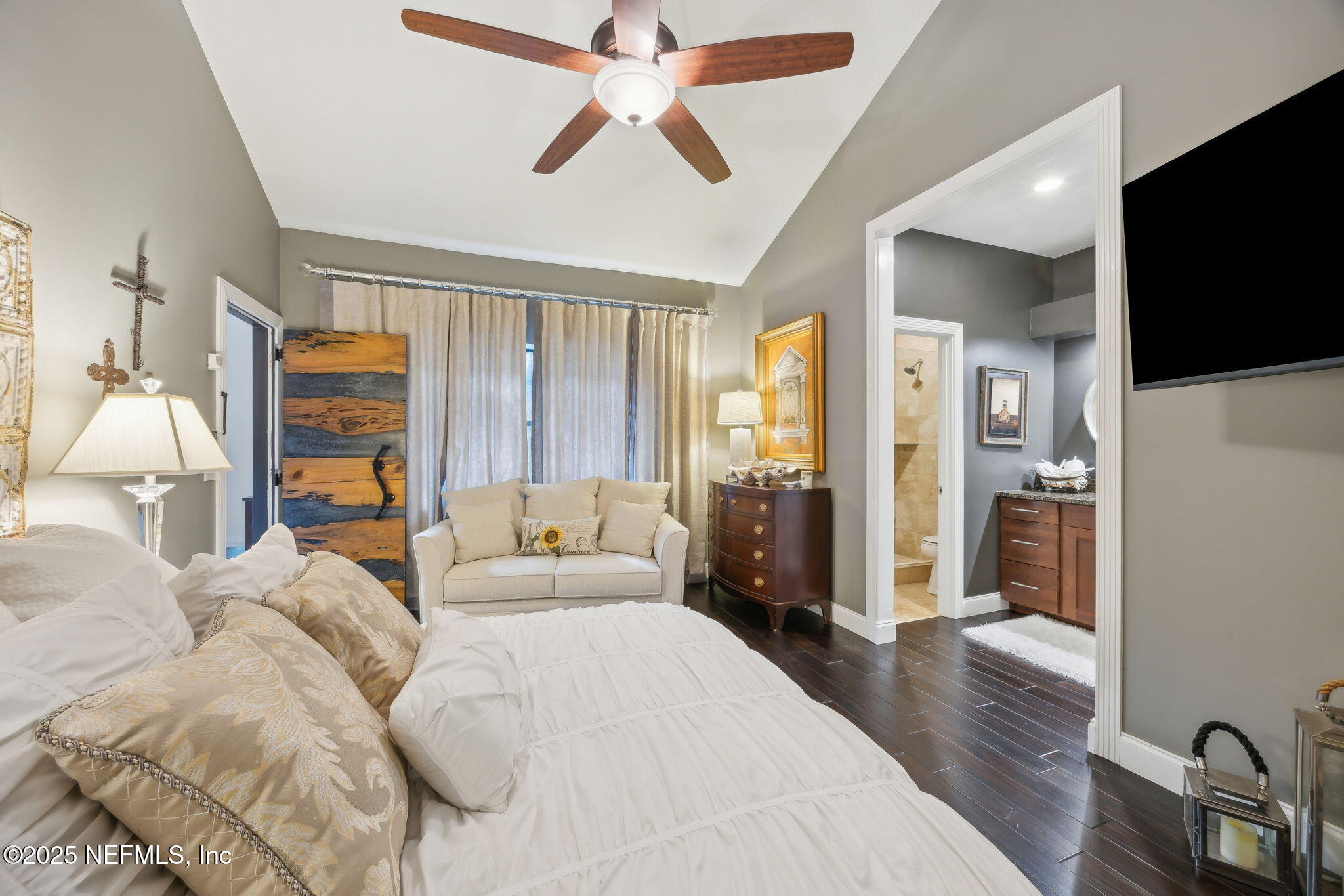 2245 Reed Street Orange Park, FL 32073 - Photo 51 of 107 a spacious bedroom with a bed and a flat screen tv