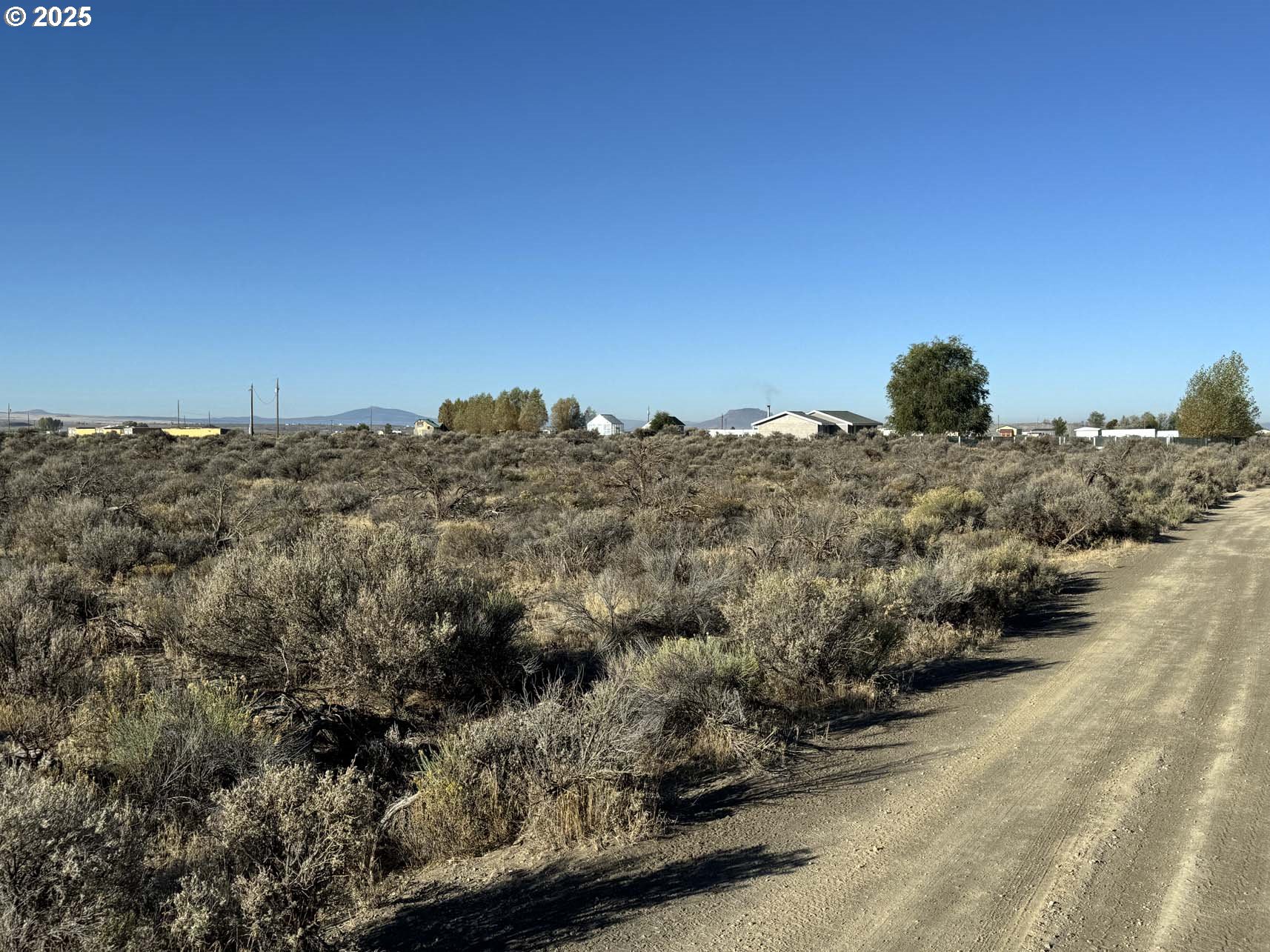 Pinion Lane, Unit 9200 Christmas Valley, OR 97641 - Photo 28 of 34 a view of a large building with mountains in the background
