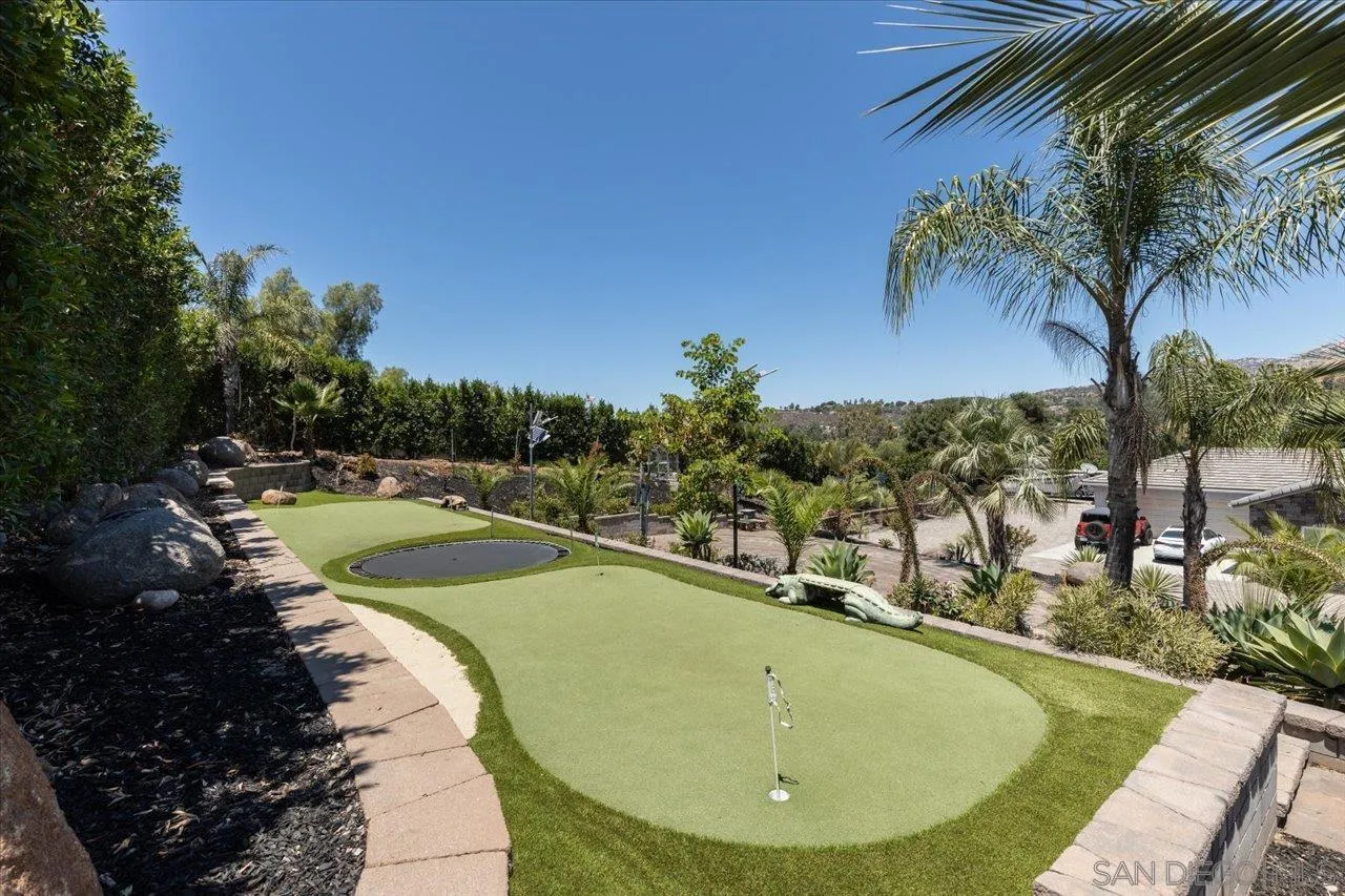 15786 Olde Highway 80 El Cajon, CA 92021 - Photo 4 of 75 a view of a swimming pool with a garden