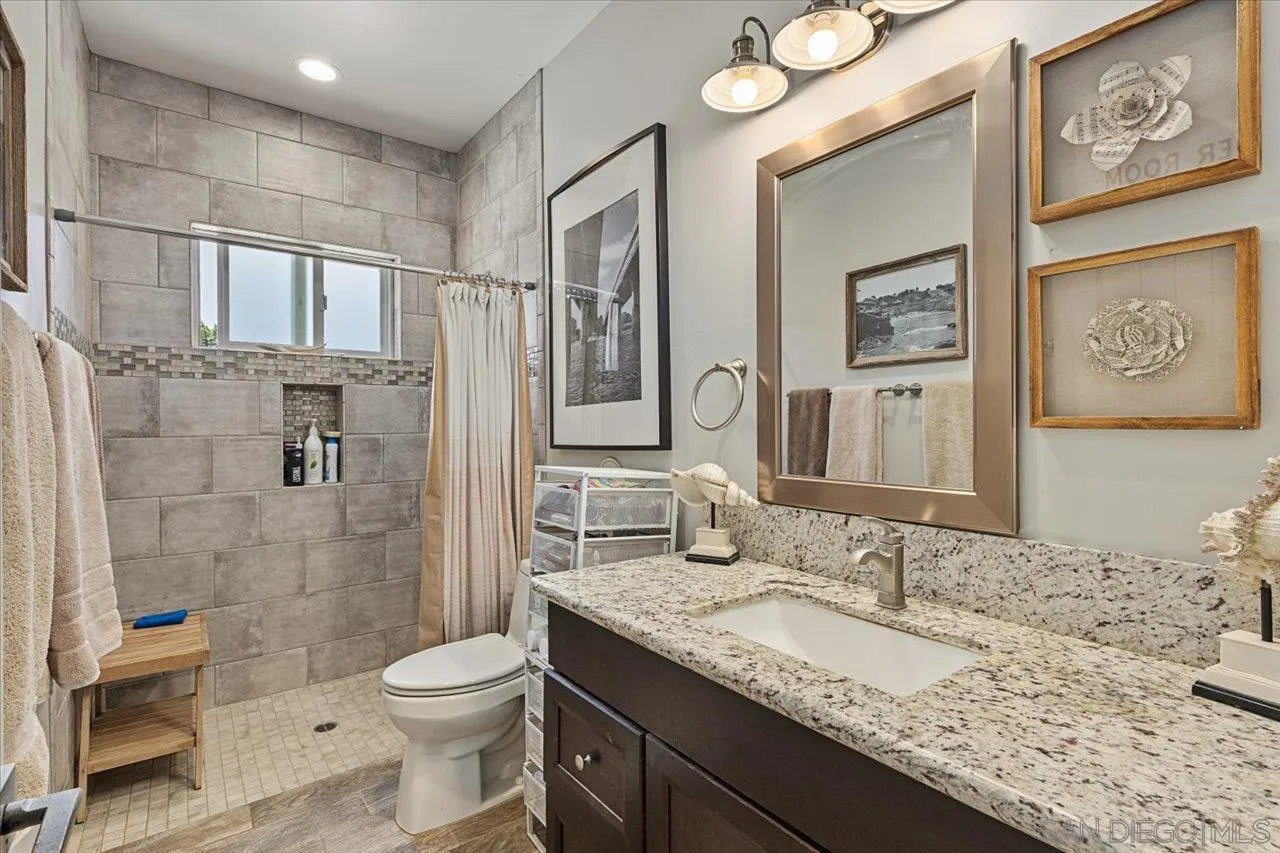 15786 Olde Highway 80 El Cajon, CA 92021 - Photo 64 of 75 a bathroom with a granite countertop sink toilet and shower