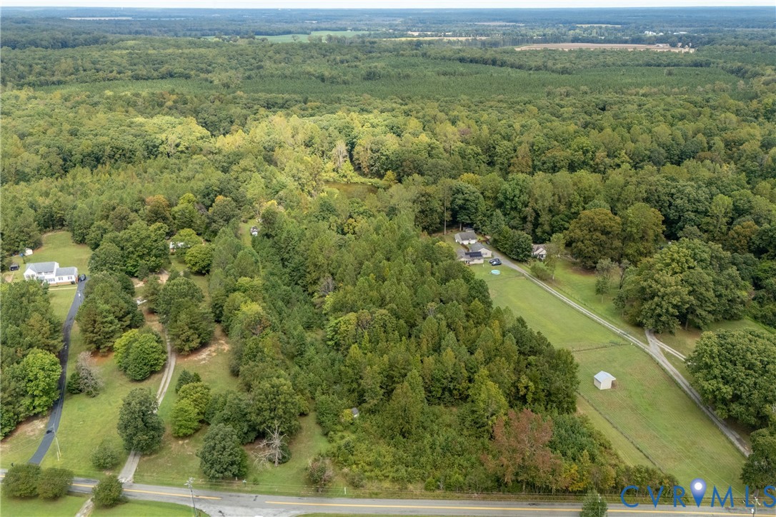 5210 Hopewell Road New Kent, VA 23124 - Photo 11 of 14 a view of a field with a lush green forest