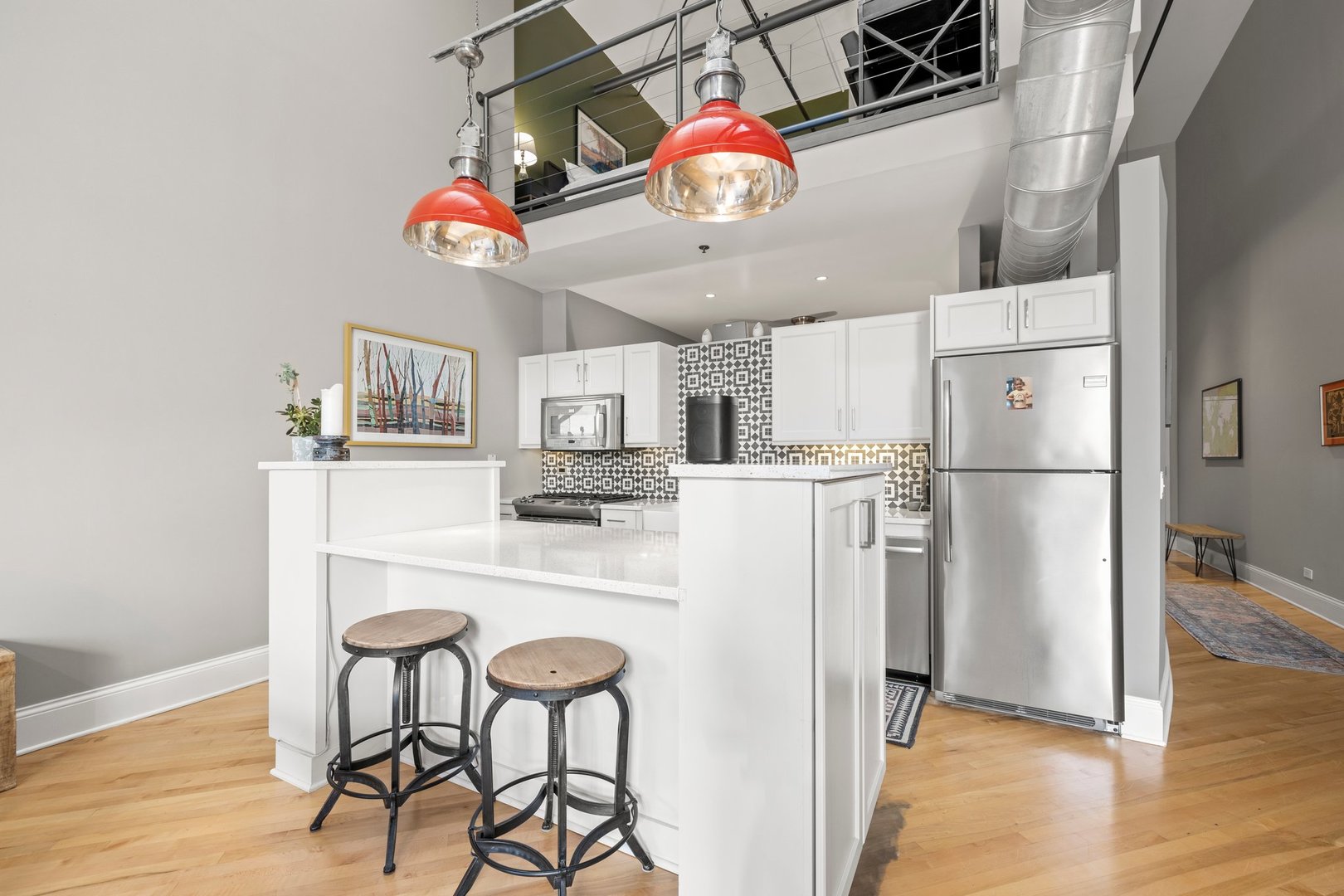 203 South Sangamon Street, Unit 306 Chicago, IL 60607 - Photo 11 of 30 a kitchen with stainless steel appliances granite countertop a refrigerator a microwave oven a sink and white countertops with wooden floor