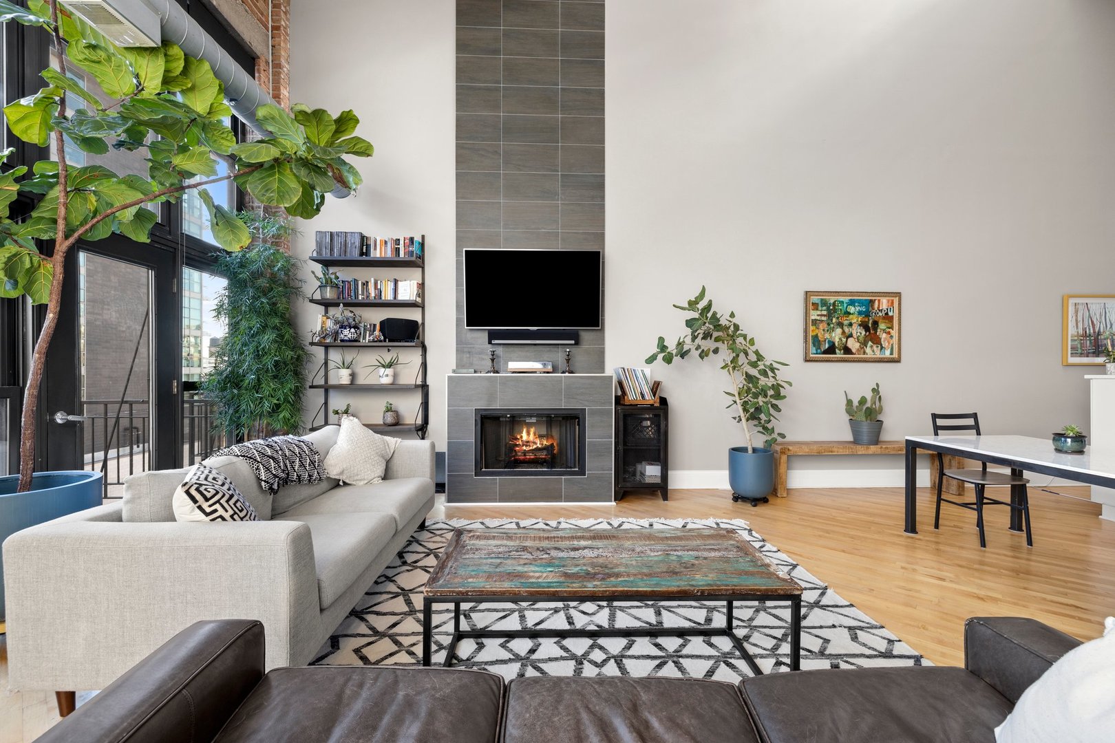203 South Sangamon Street, Unit 306 Chicago, IL 60607 - Photo 2 of 30 a living room with furniture a fireplace and a flat screen tv