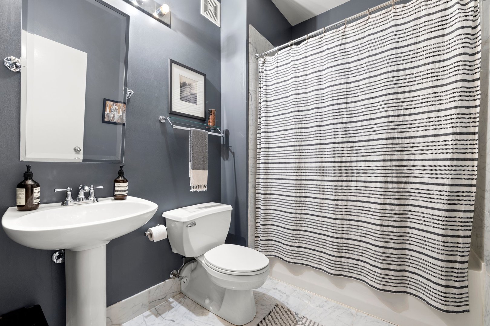 203 South Sangamon Street, Unit 306 Chicago, IL 60607 - Photo 23 of 30 a bathroom with a sink a toilet and mirror