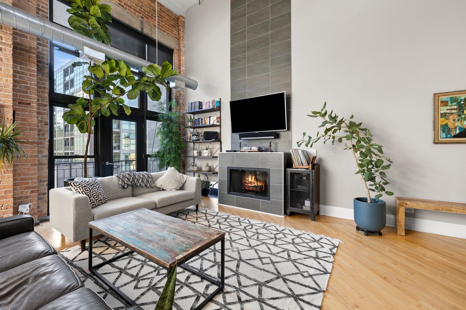 203 South Sangamon Street, Unit 306 Chicago, IL 60607 - Photo 3 of 30 a living room with furniture a flat screen tv and a fireplace