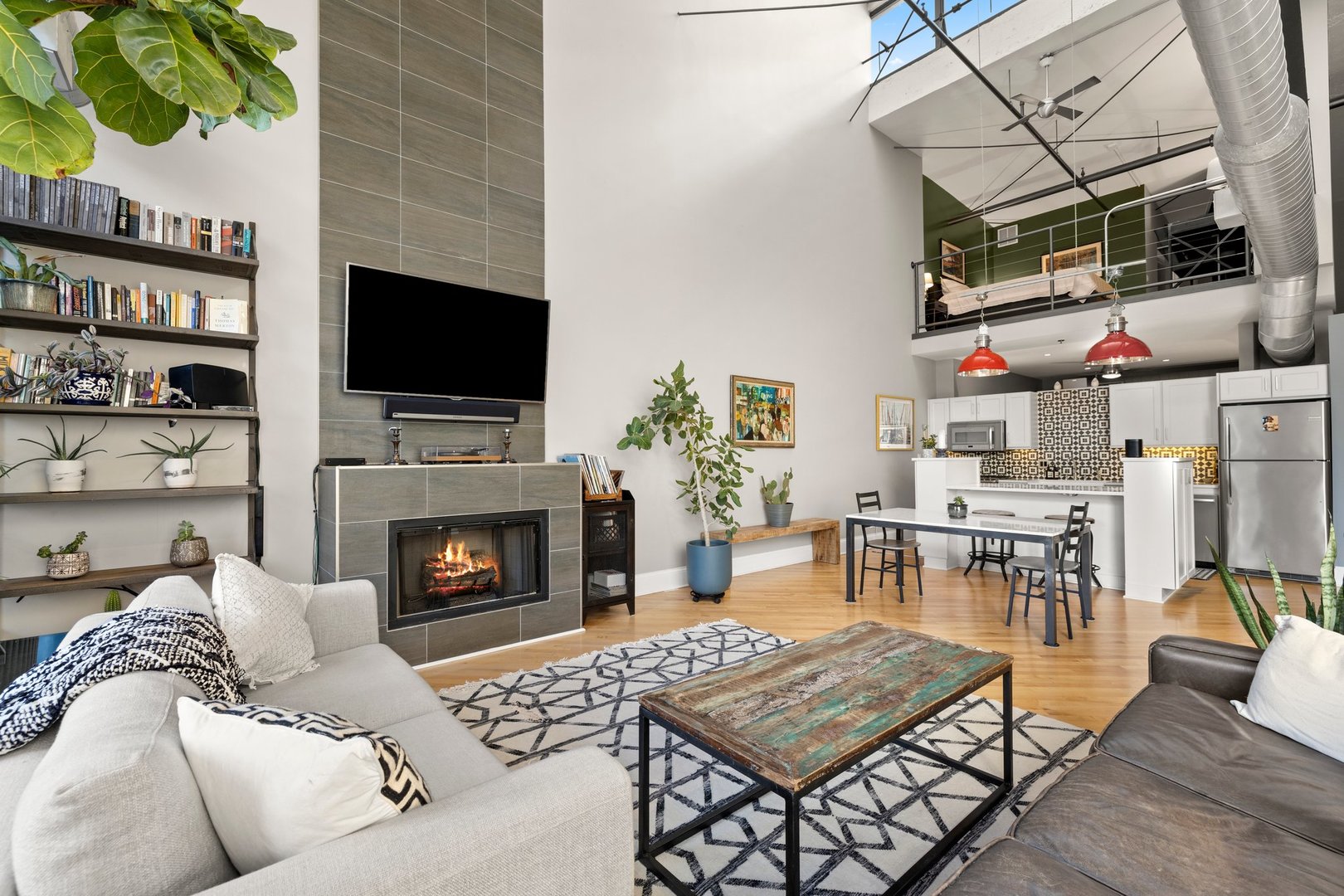 203 South Sangamon Street, Unit 306 Chicago, IL 60607 - Photo 6 of 30 a living room with furniture a flat screen tv and a fireplace