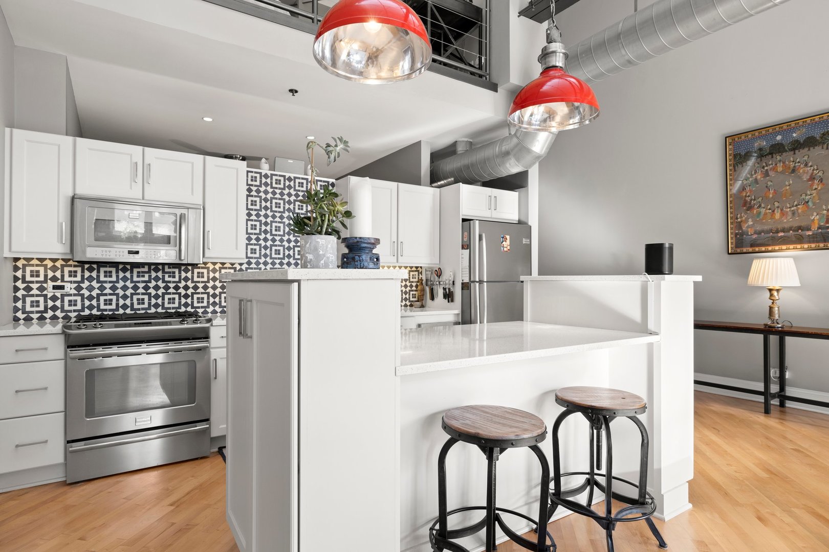 203 South Sangamon Street, Unit 306 Chicago, IL 60607 - Photo 10 of 30 a kitchen with furniture a chandelier and stainless steel appliances