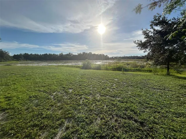 a view of a lake with houses in the back