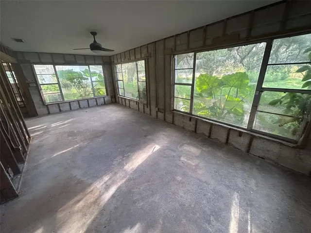a view of an empty room with a sliding door and wooden floor