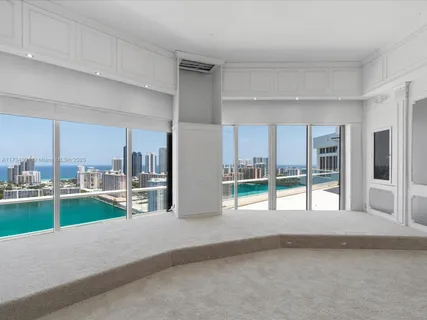 a open kitchen with granite countertop a refrigerator a sink and white cabinets