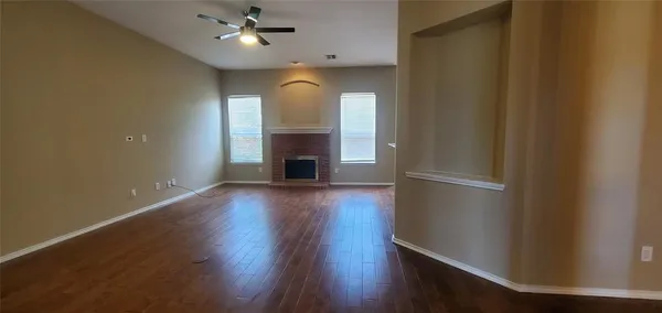 wooden floor in an empty room with a fireplace