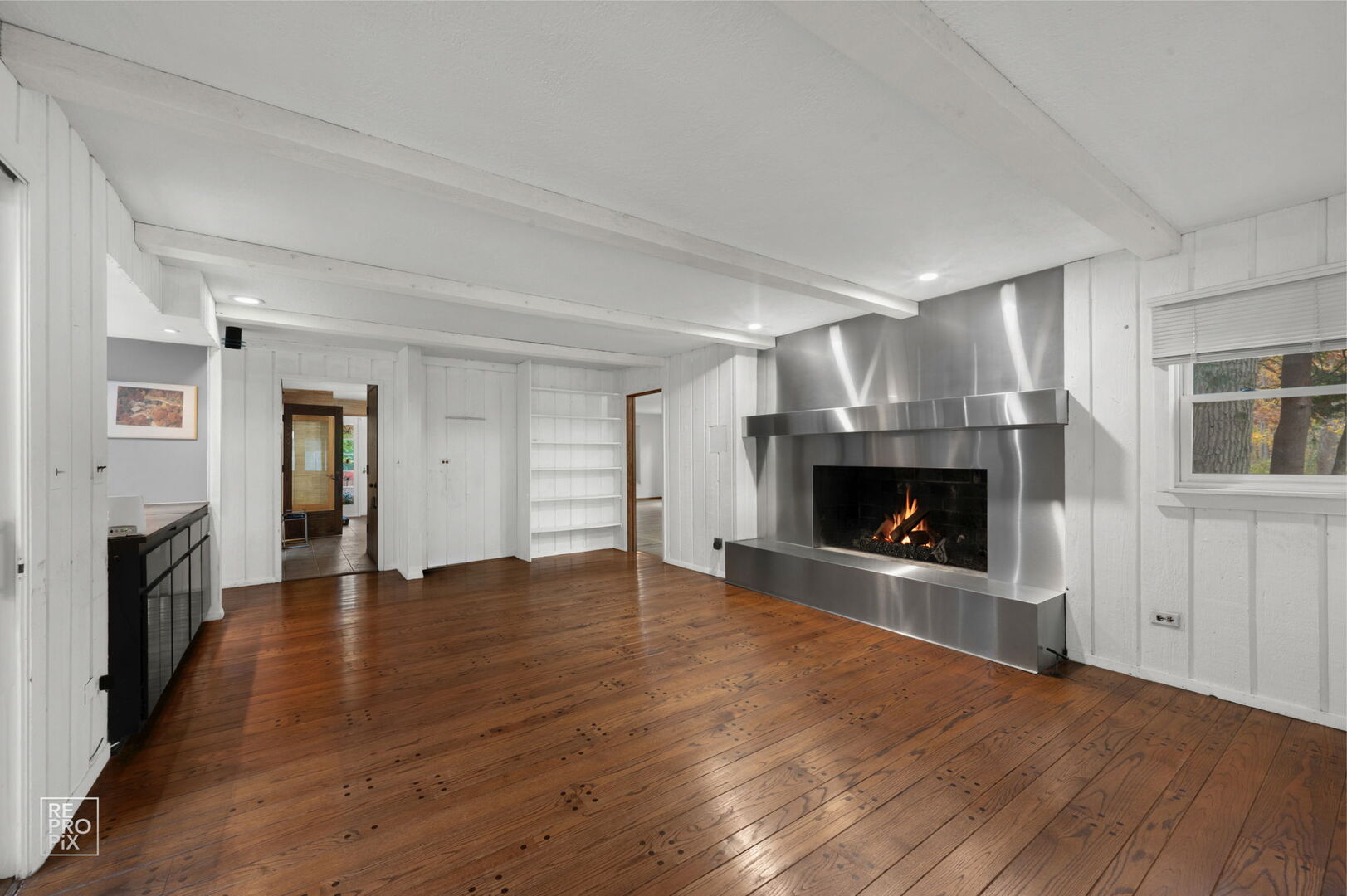 14930 West Wadsworth Road Wadsworth, IL 60083 - Photo 13 of 68 an empty room with wooden floor fireplace and windows
