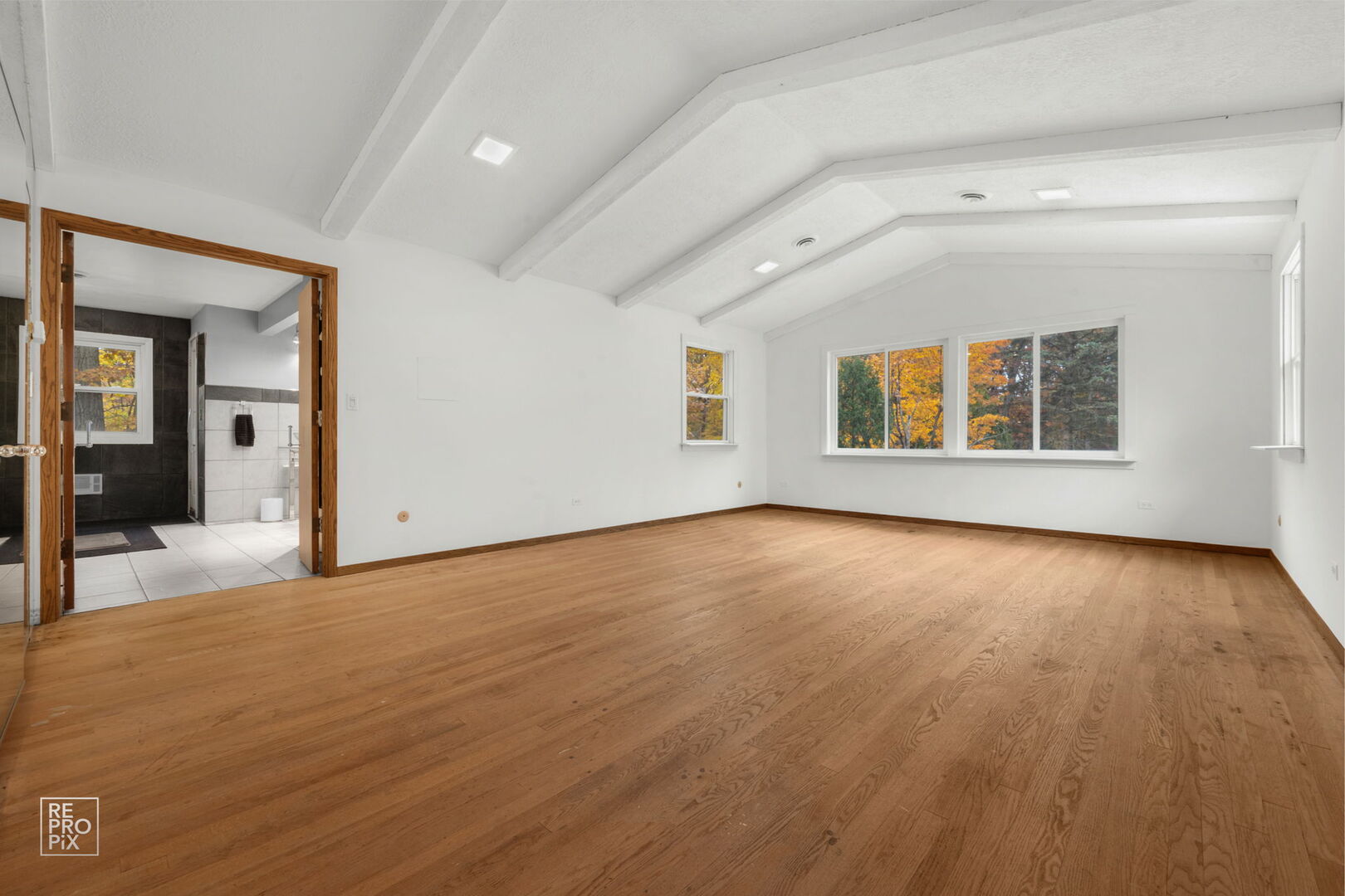 14930 West Wadsworth Road Wadsworth, IL 60083 - Photo 30 of 68 an empty room with wooden floor and windows
