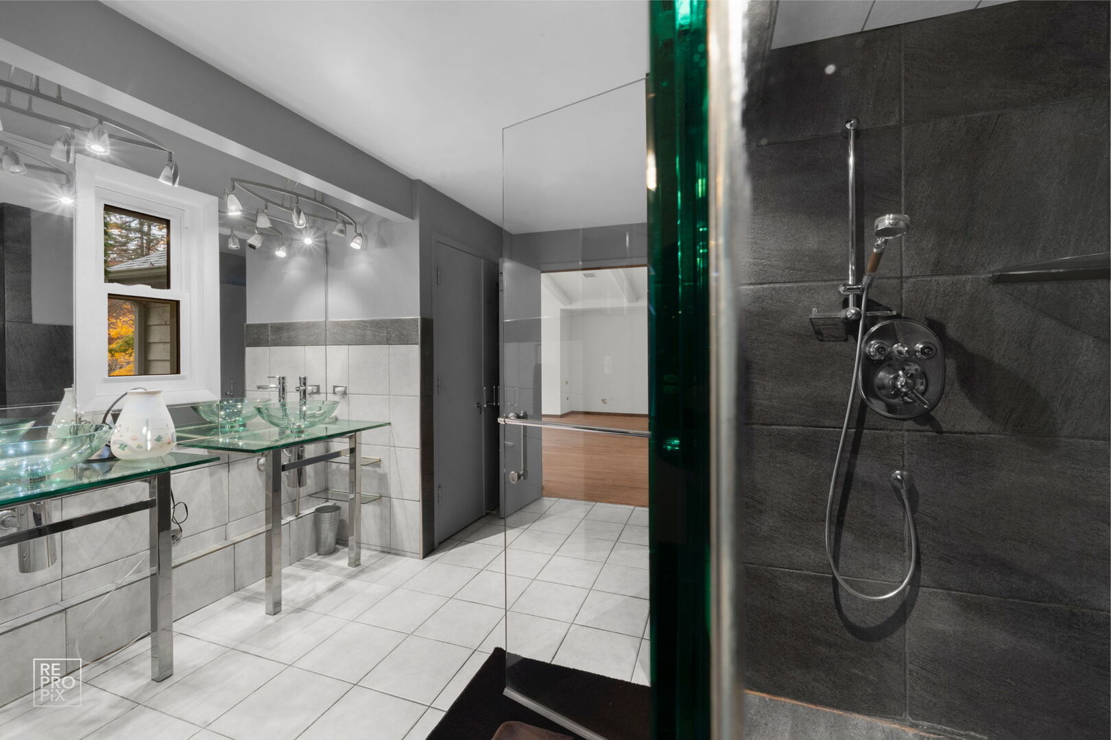 14930 West Wadsworth Road Wadsworth, IL 60083 - Photo 32 of 68 a bathroom with a granite countertop sink a mirror and a shower