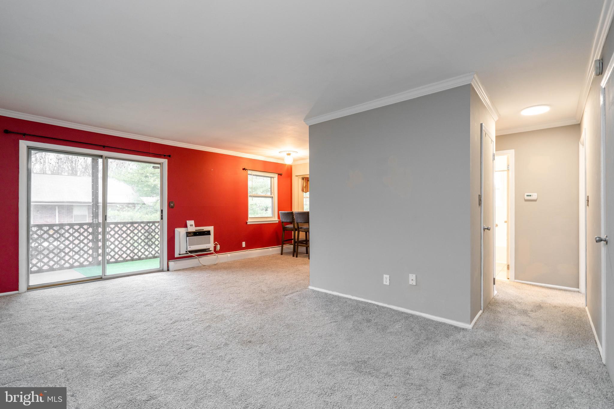 902 Garnet Drive Burlington, NJ 08016 - Photo 3 of 15 an empty room with large windows and a couch