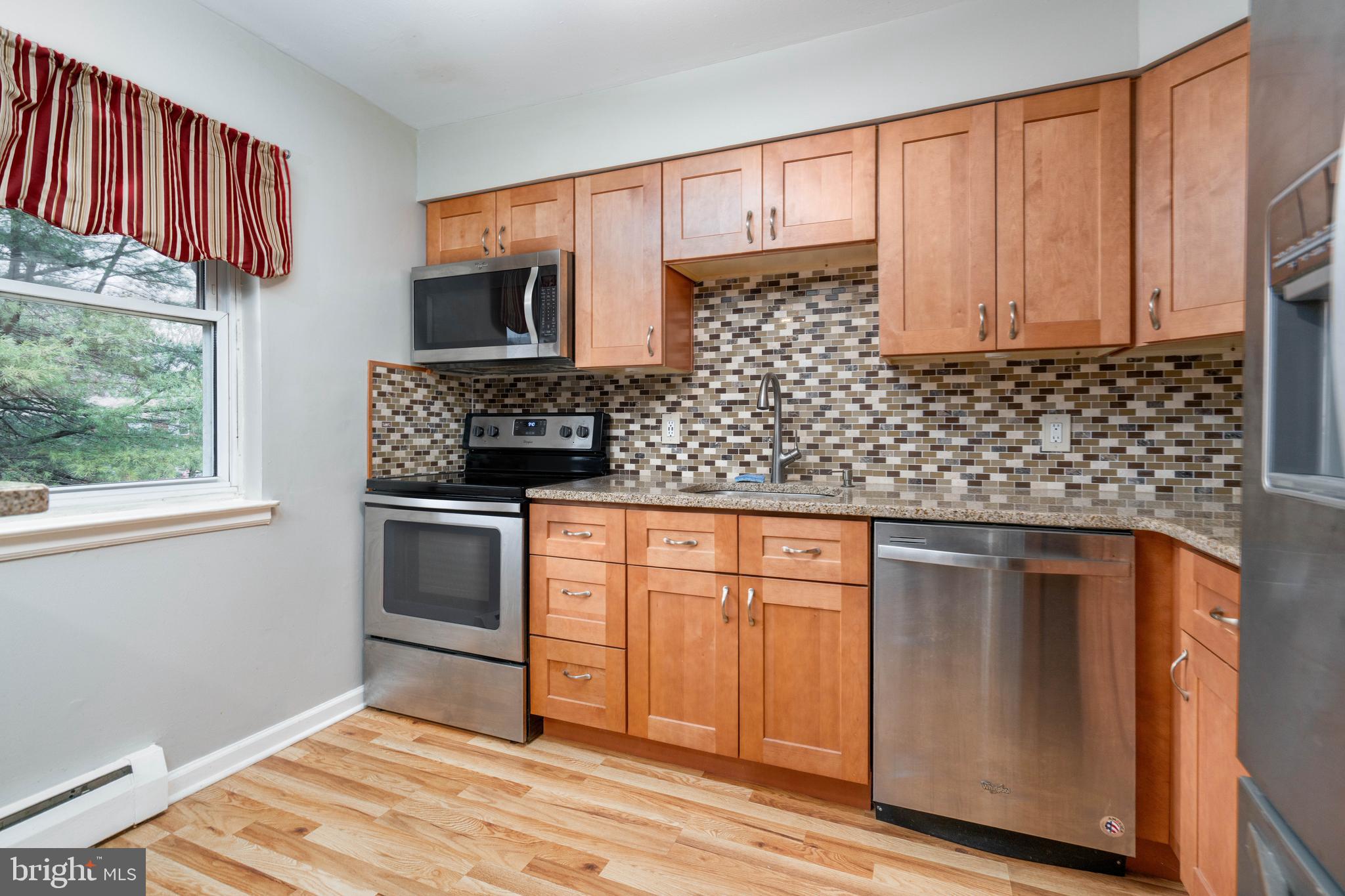 902 Garnet Drive Burlington, NJ 08016 - Photo 6 of 15 a kitchen with stainless steel appliances granite countertop a stove a sink and a microwave