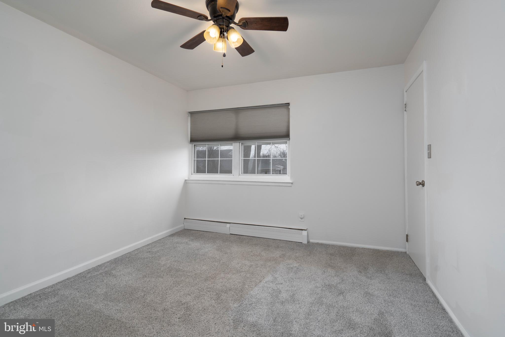 902 Garnet Drive Burlington, NJ 08016 - Photo 7 of 15 an empty room with a window and ceiling fan