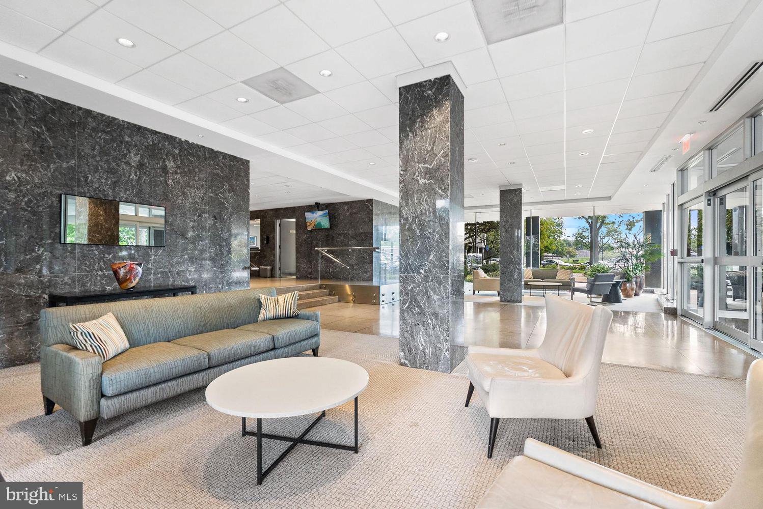 2475 Virginia Avenue Northwest, Unit 917 Washington, DC 20037 - Photo 18 of 21 a living room with furniture and a large window