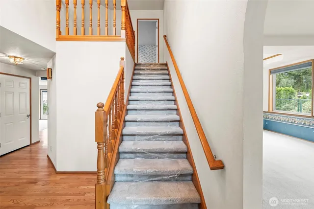 a bedroom with a bed a mirror on dresser and a chandelier