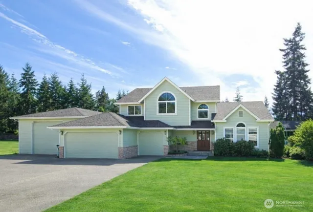 a front view of a house with a yard and garage