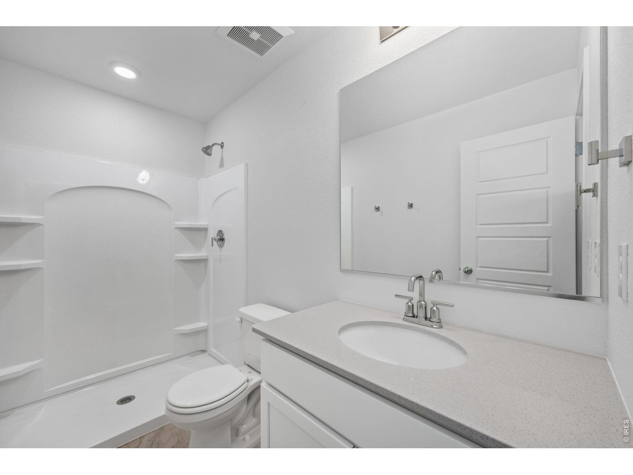 3905 Net Street Evans, CO 80620 - Photo 12 of 19 a bathroom with a sink a toilet a mirror and shower