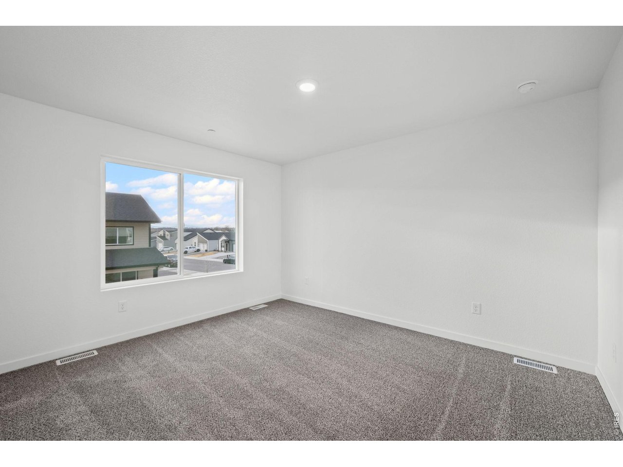 3905 Net Street Evans, CO 80620 - Photo 13 of 19 a view of an empty room with a window