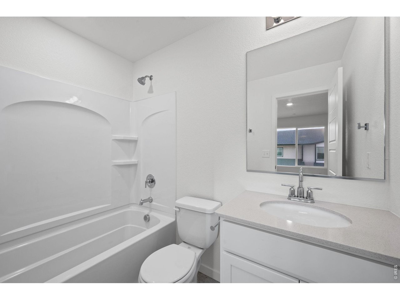 3905 Net Street Evans, CO 80620 - Photo 14 of 19 a bathroom with a granite countertop sink a toilet a mirror and shower
