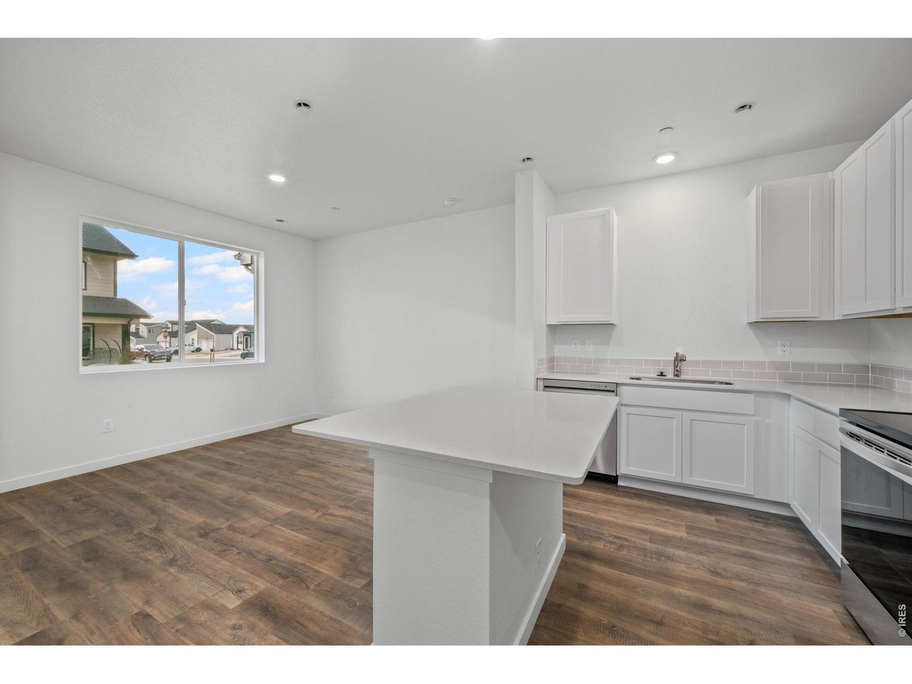 3905 Net Street Evans, CO 80620 - Photo 5 of 19 a kitchen with a sink cabinets and wooden floor