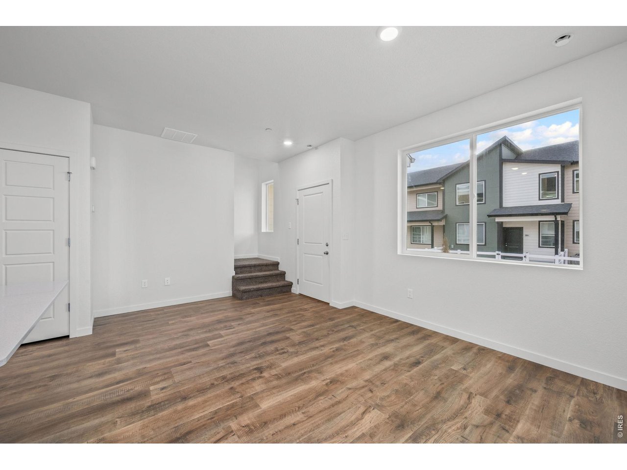 3905 Net Street Evans, CO 80620 - Photo 7 of 19 a view of an empty room with wooden floor and a window