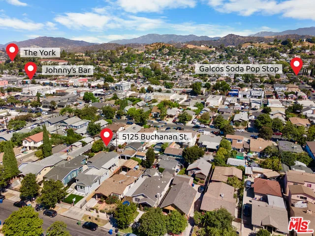 an aerial view of residential houses with outdoor space