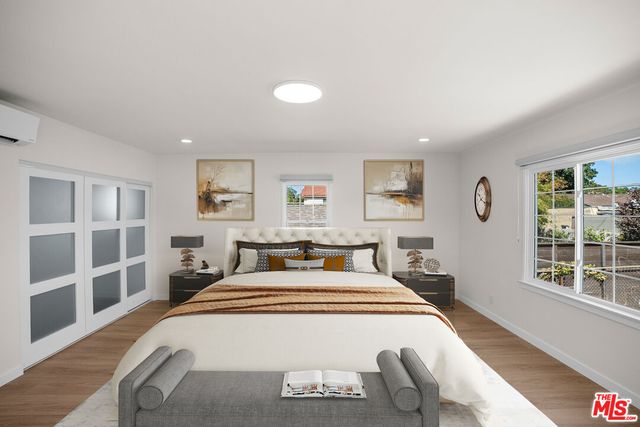 a bedroom with a bed and a large window