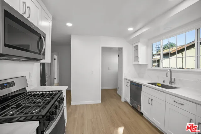 a kitchen with a sink stove and microwave