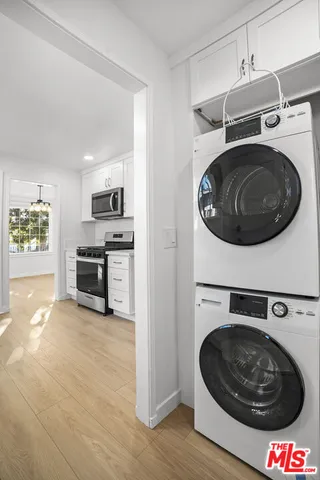 a utility room with sink dryer and washer