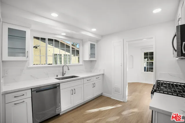 a kitchen with a sink stove and cabinets