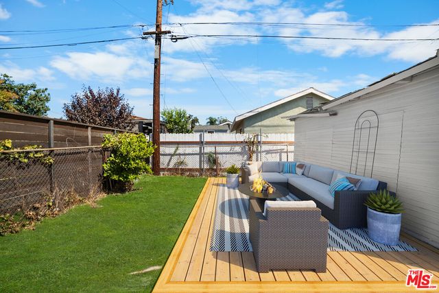 a view of a couches and dinning table in patio