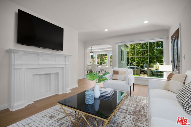 a living room with fireplace furniture and a flat screen tv