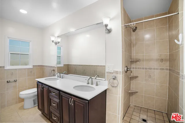 a bathroom with a sink double vanity and a mirror
